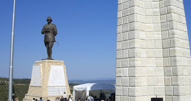 A statue of a soldier and an obelisk monument.