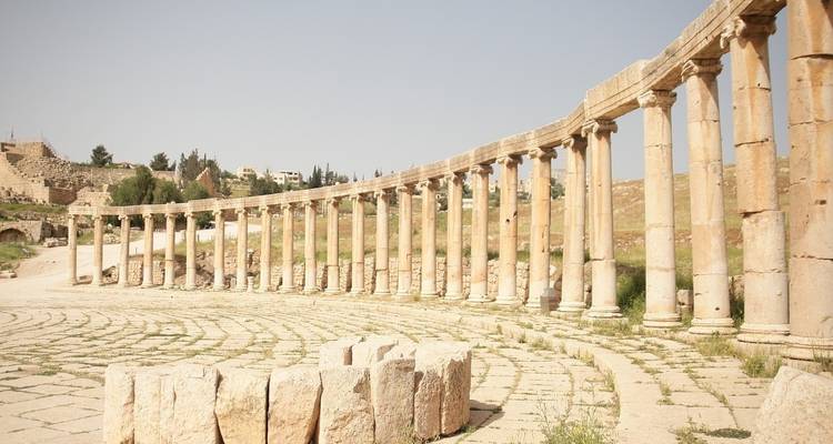 Ancient Roman columns forming a semi-circle in an open area.