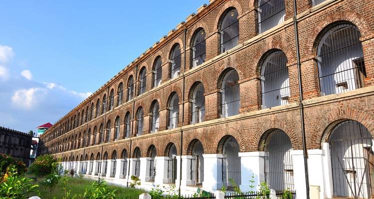 A historic brick building with multiple archways.