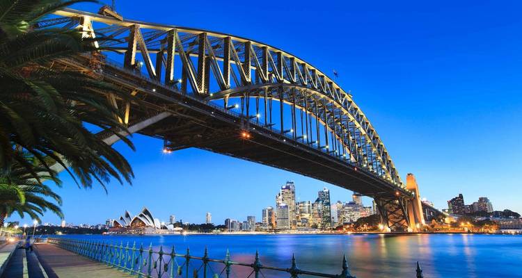 Le pont du port de Sydney avec l'Opéra en vue le soir.