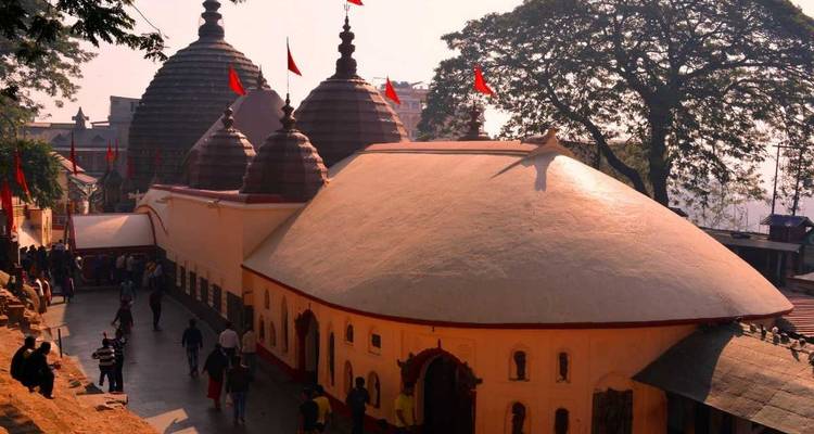 Temple complex with domed roofs and people walking around.