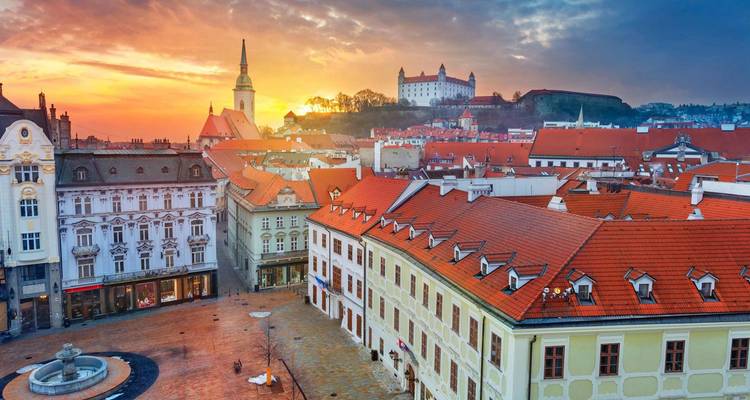 Charming cityscape of Bratislava with the castle visible at sunset.