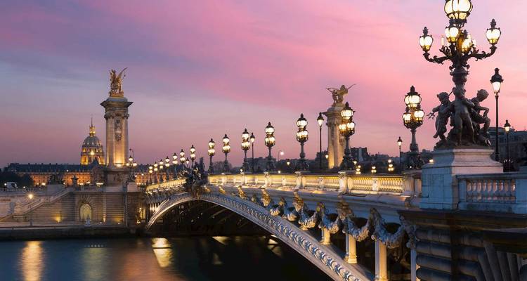 Pont Alexandre III à Paris illuminé au coucher du soleil.