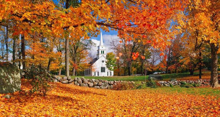 Église rurale pittoresque entourée de feuillage d'automne coloré.