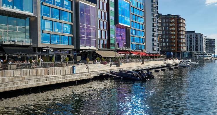 Modern harbor front with vibrant city buildings along the water.
