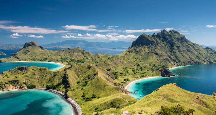 Spectacular aerial panorama of green ridged islands with crescent beaches and deep blue bays