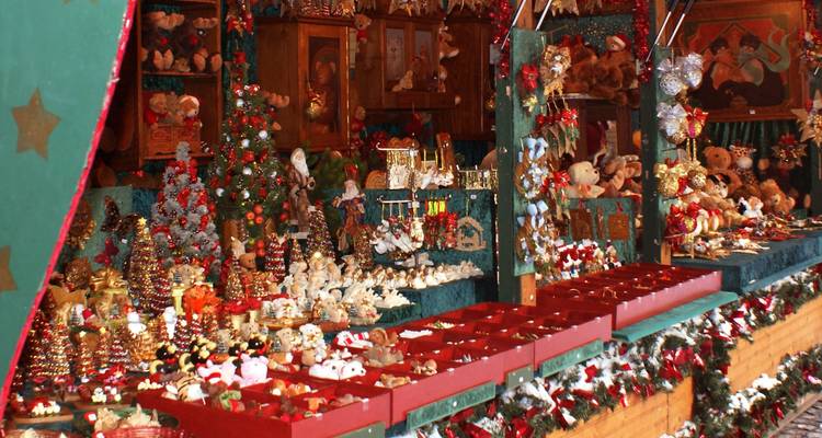 Puesto del mercado navideño con juguetes de colores y decoración festiva.