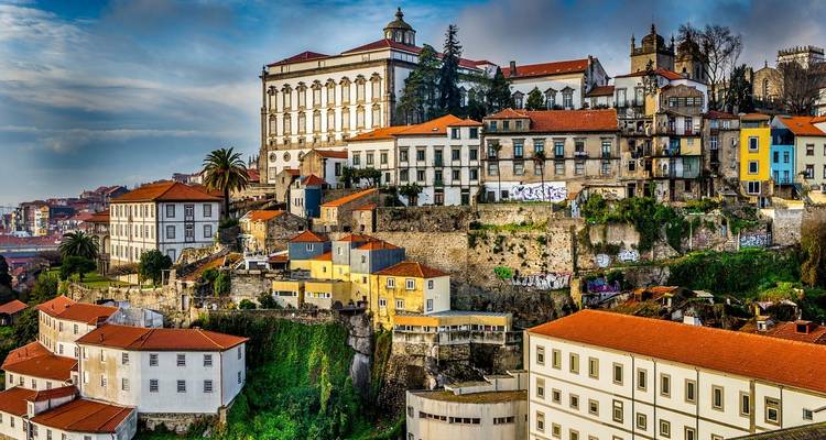 Colorful hillside houses and churches cascading toward the Douro River in historic Porto.