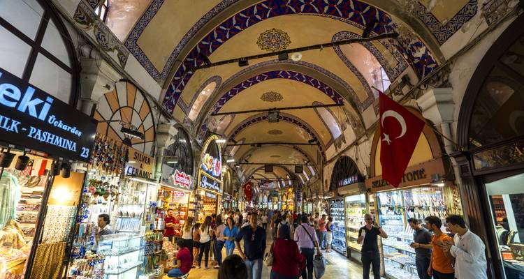 Interior of a vibrant market with people shopping.