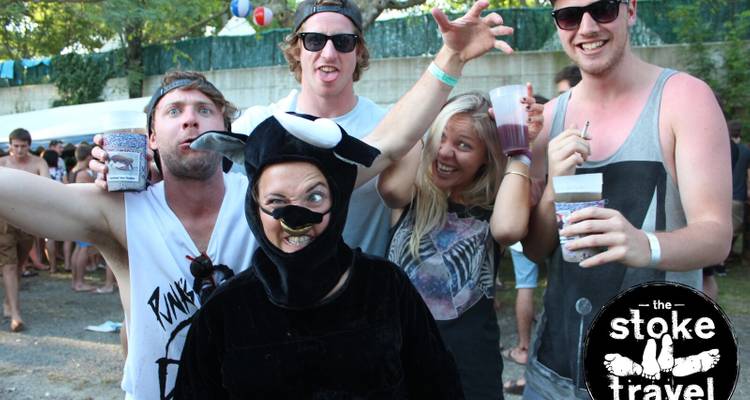 Group of people in colorful costumes at an outdoor event, with visible watermark.