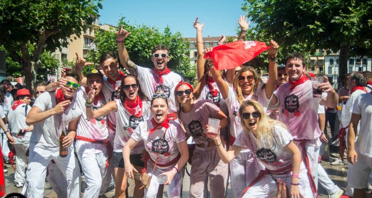 Group of happy people celebrating with red and white attire.