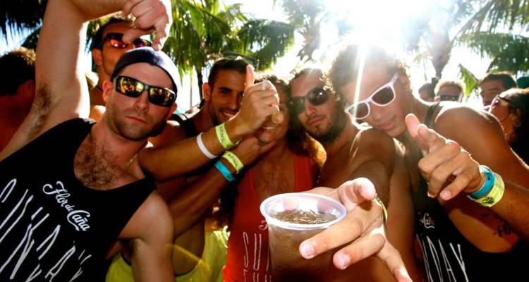 Group of young people at a lively outdoor party, showing a festive mood.