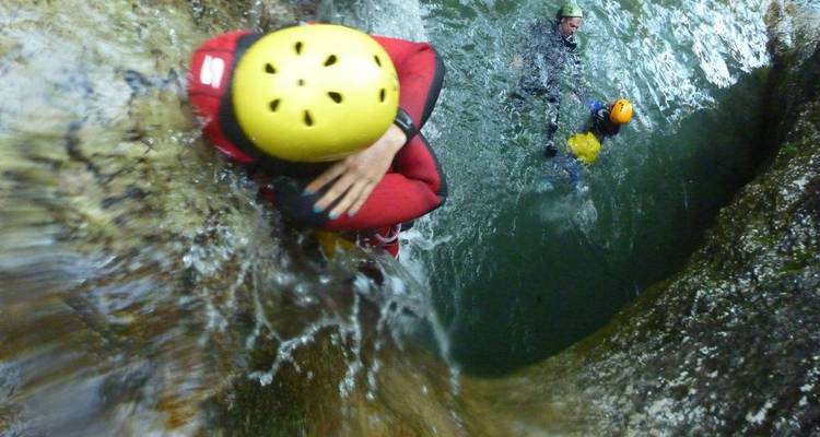 Person climbing a rock in a canyon