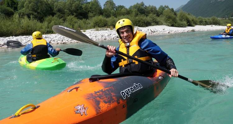 Person kayaking on a turquoise river