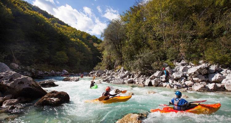 Kayakers navigating a fast-flowing river