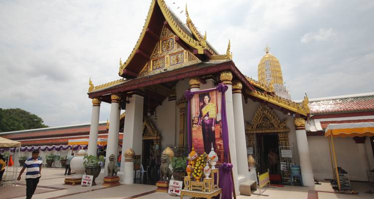 Temple entrance with decorative pillars and a large portrait.