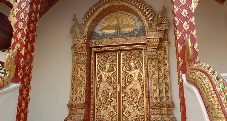 Ornate red and gold temple doors with intricate carvings.